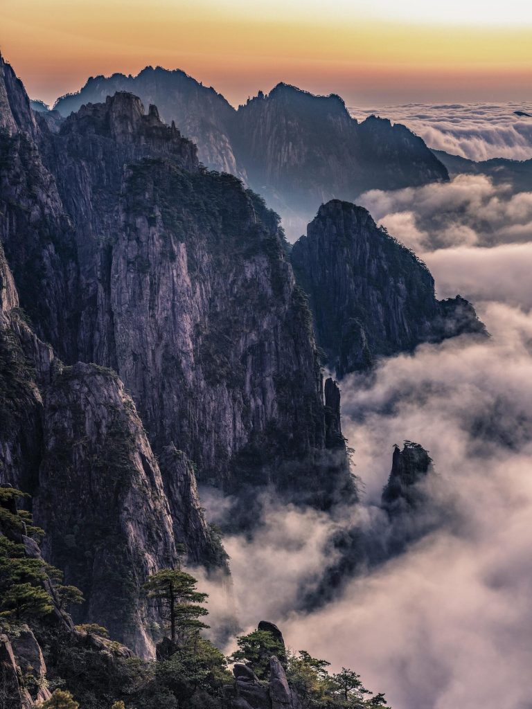 A panoramic view of vast mountains shrouded in mist, representing the Taihang Mountain range during the Shanxi Taihang Exploration.
