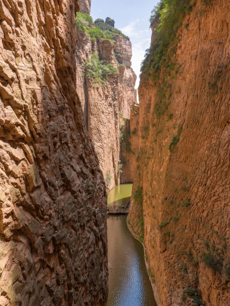 A serene river flowing through a narrow canyon, part of the Shanxi Taihang Exploration.