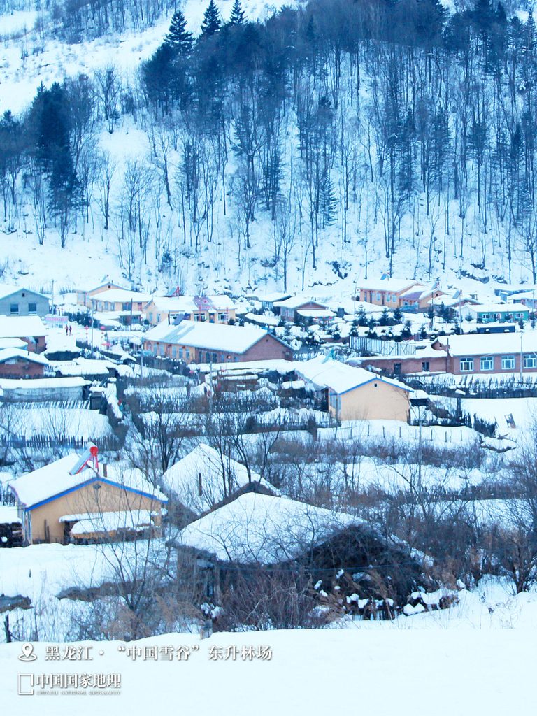 A snowy village landscape with traditional Chinese houses, showcasing the winter beauty experienced during the Shanxi Taihang Exploration.