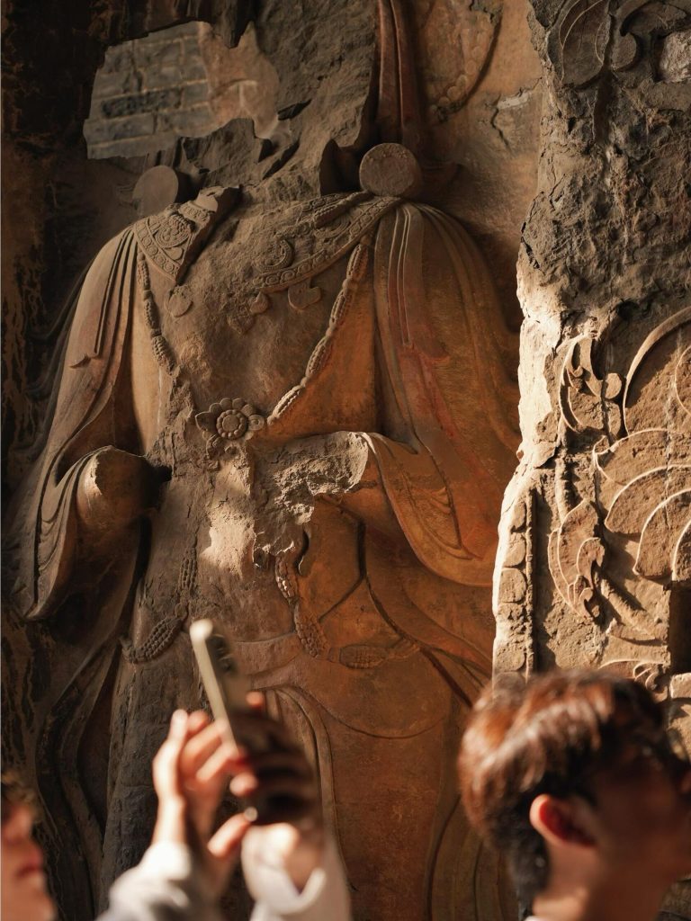 Ancient Buddhist carvings in a grotto, reflecting the rich history and culture of the Shanxi Taihang Exploration region.