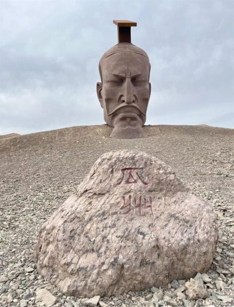 The massive 'Son of the Earth' sculpture in the Gobi Desert, a modern art piece on the Hexi Corridor Adventure route.