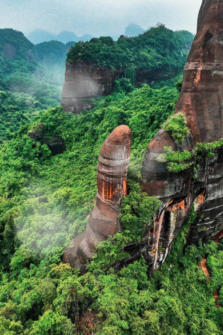 Majestic red sandstone peaks of Danxia Mountain, a prime example of Karst Landscape Wonders.