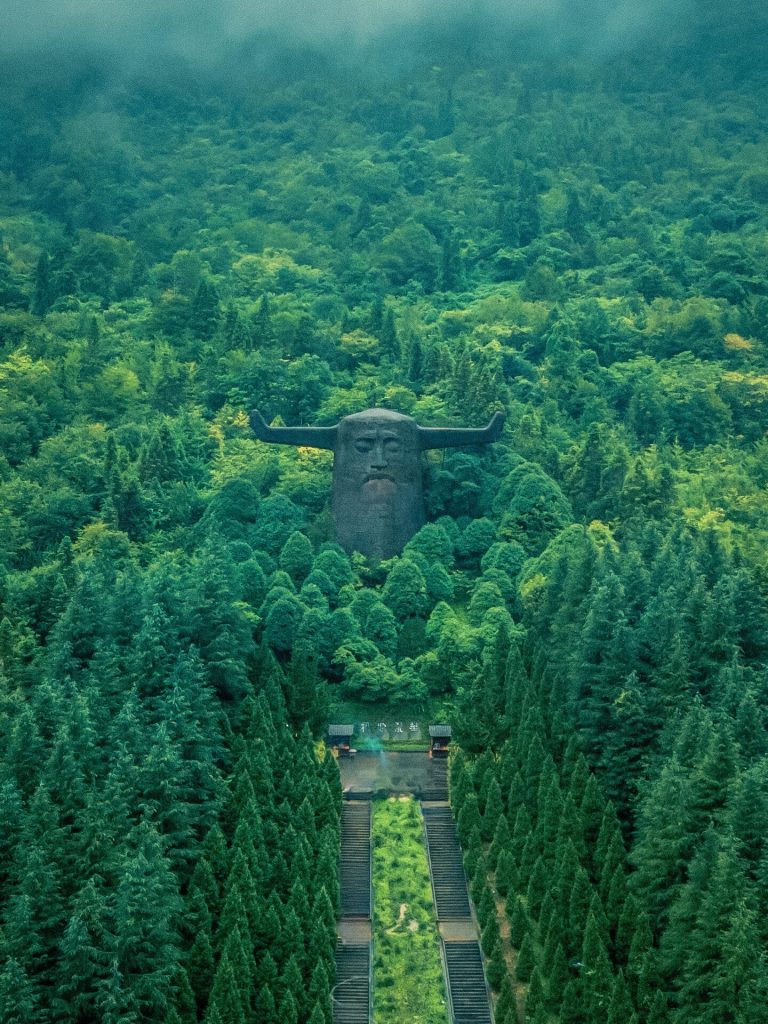 An aerial view of the Shennong Altar and its surrounding lush forests, a serene part of the Hubei historical journey.