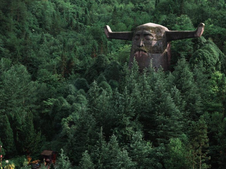The ancient Shennong statue, shrouded in mist, a spiritual centerpiece of the Hubei historical journey.