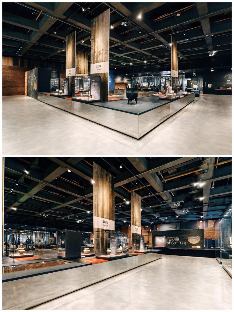 Interior of an exhibition hall with ancient artifacts in display cases.